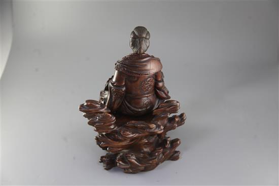 A Japanese wood okimono of the Empress-Consort Jingu seated on a rock, Meiji period, total height 35.5cm